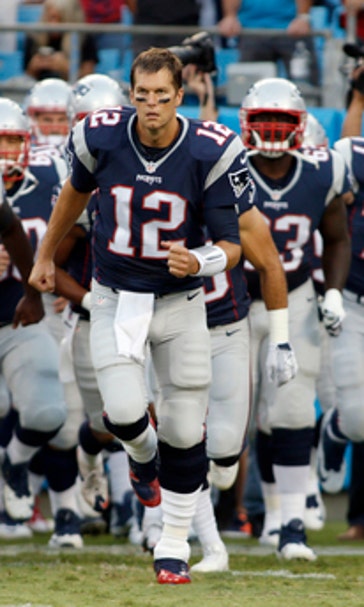 The Latest: Some raise fists, others kneel during anthem